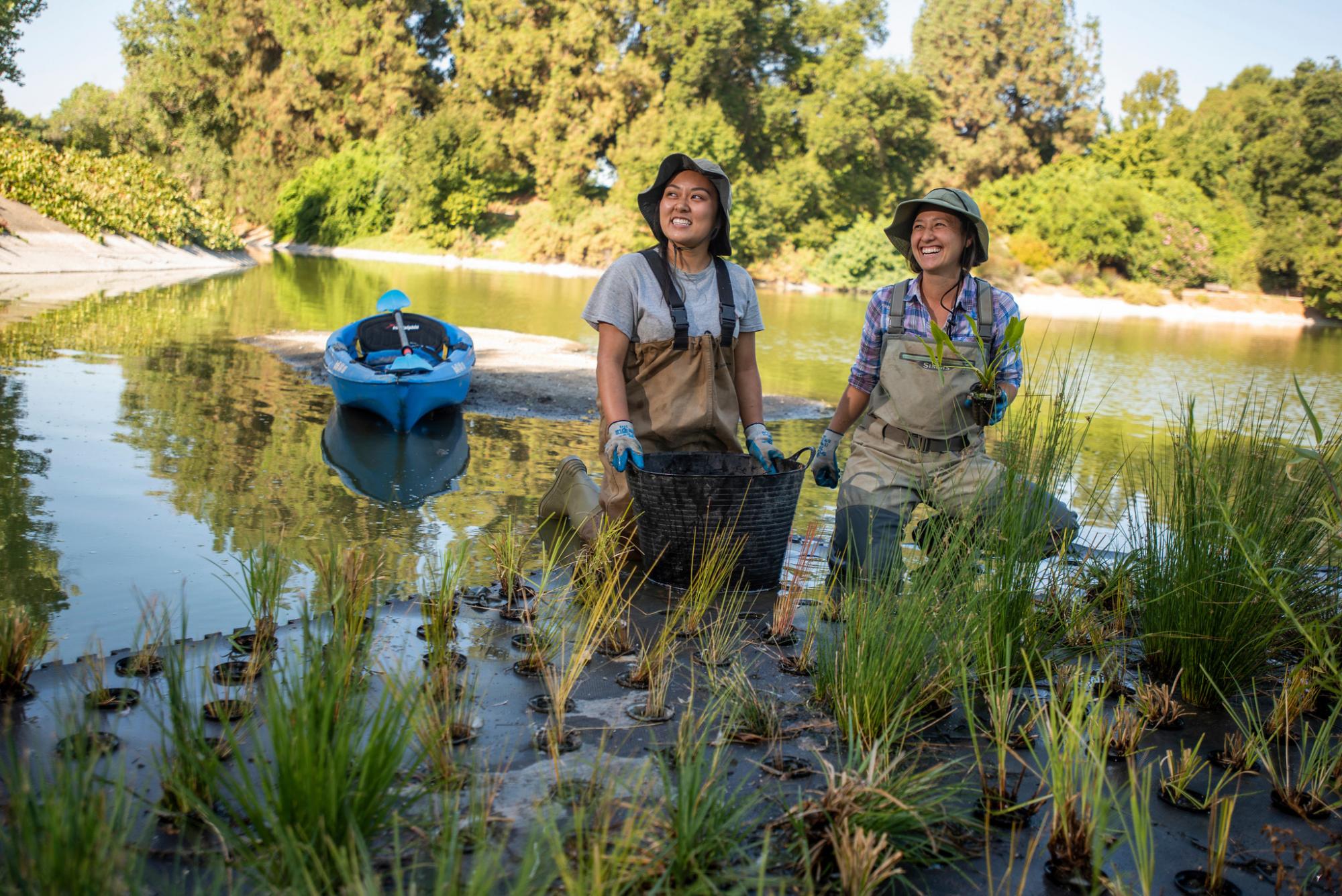 Two women stand in water
