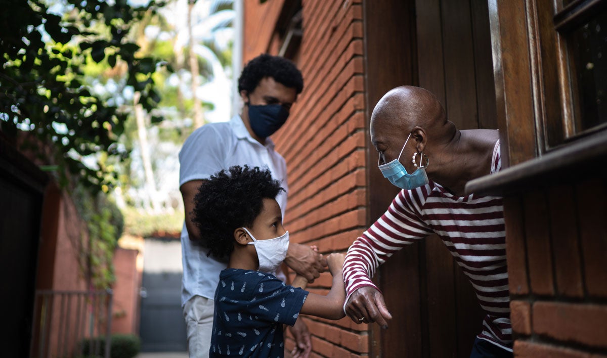 Family members in face masks, at a distance