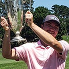 Man holding golf trophy