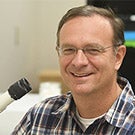 Jason Bond with microscope