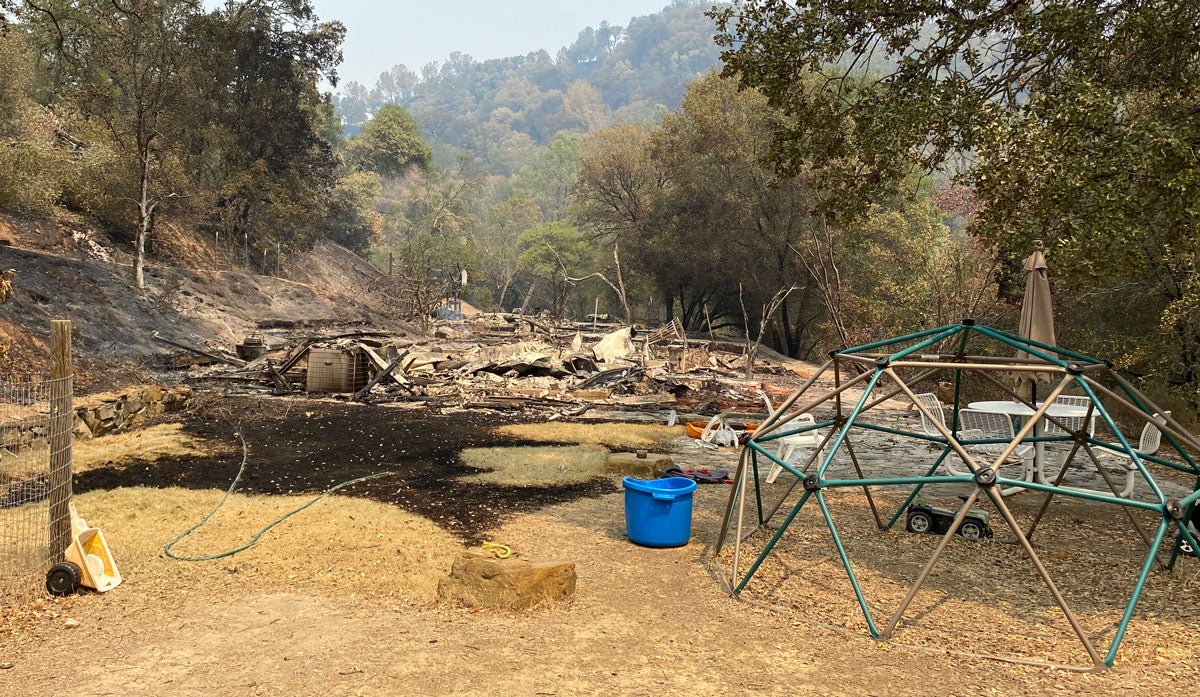 House, burned to the ground, play structure in front