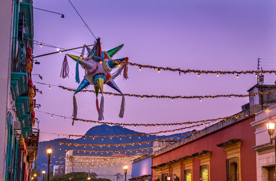 A Mexican skyline with decorations and a sparkling posada star