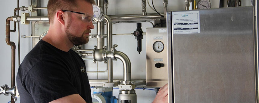 Kevin Wright working with brewing equipment