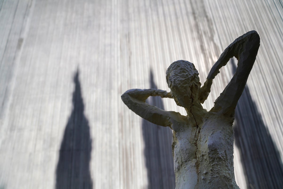 A human form statue in shadow