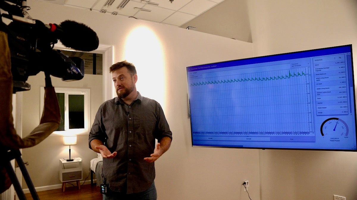 Keith Graeber is interviewed on camera in front of a blue big screen tv