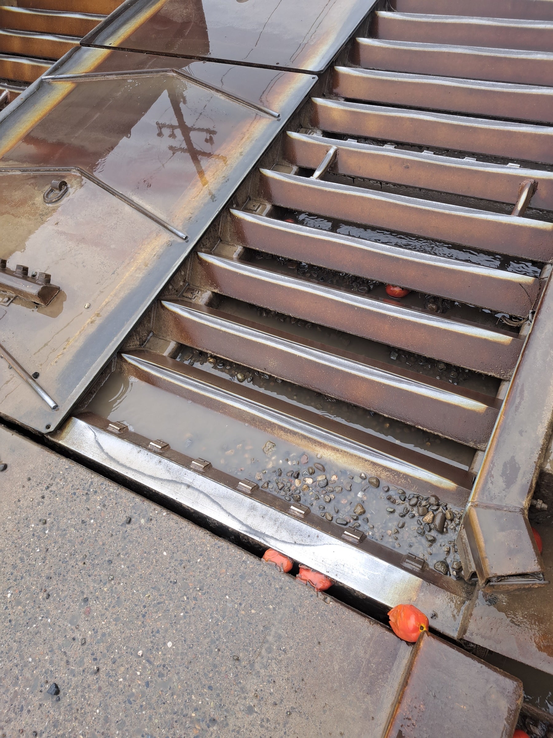 Outdoor metal wash station with a small red tomato near the bottom. (UC Davis) 