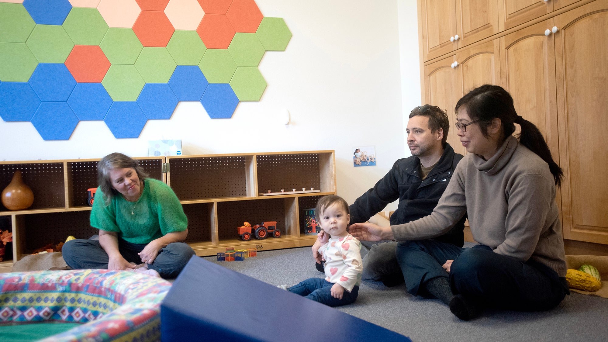 parents with a baby and a teacher