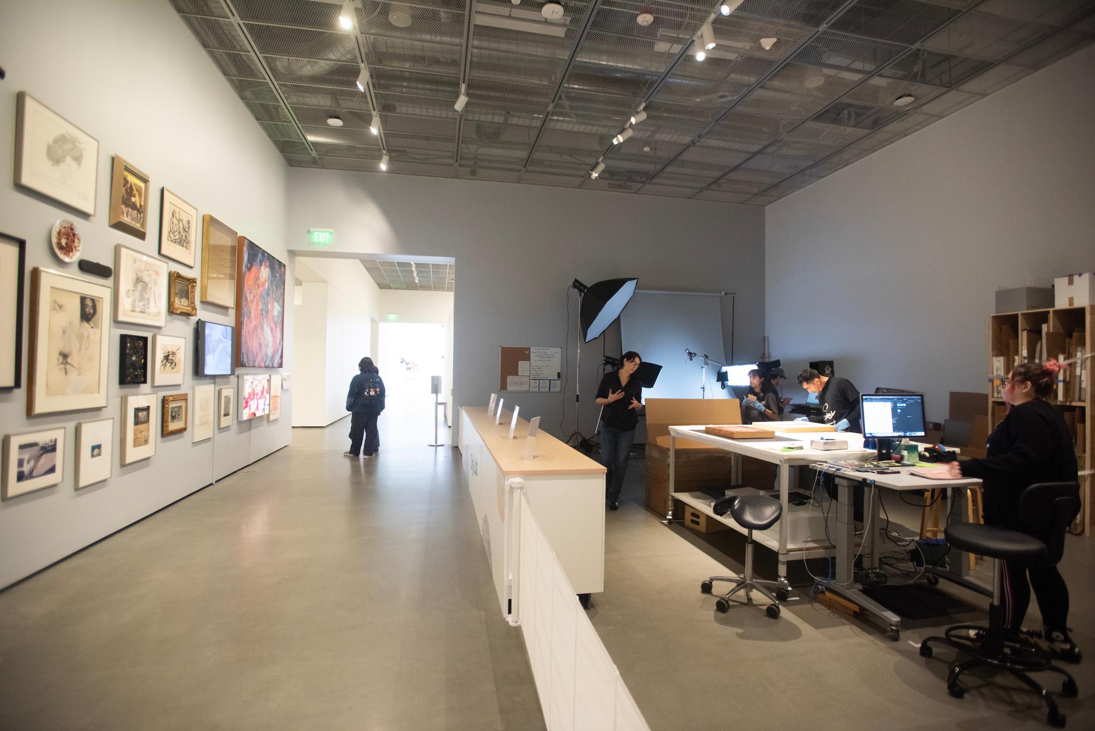 Students and museum staff photograph and record data to form a digital record of an artwork across from the gallery's Salon wall of art in the collection. (Gregory Urquiaga/UC Davis)