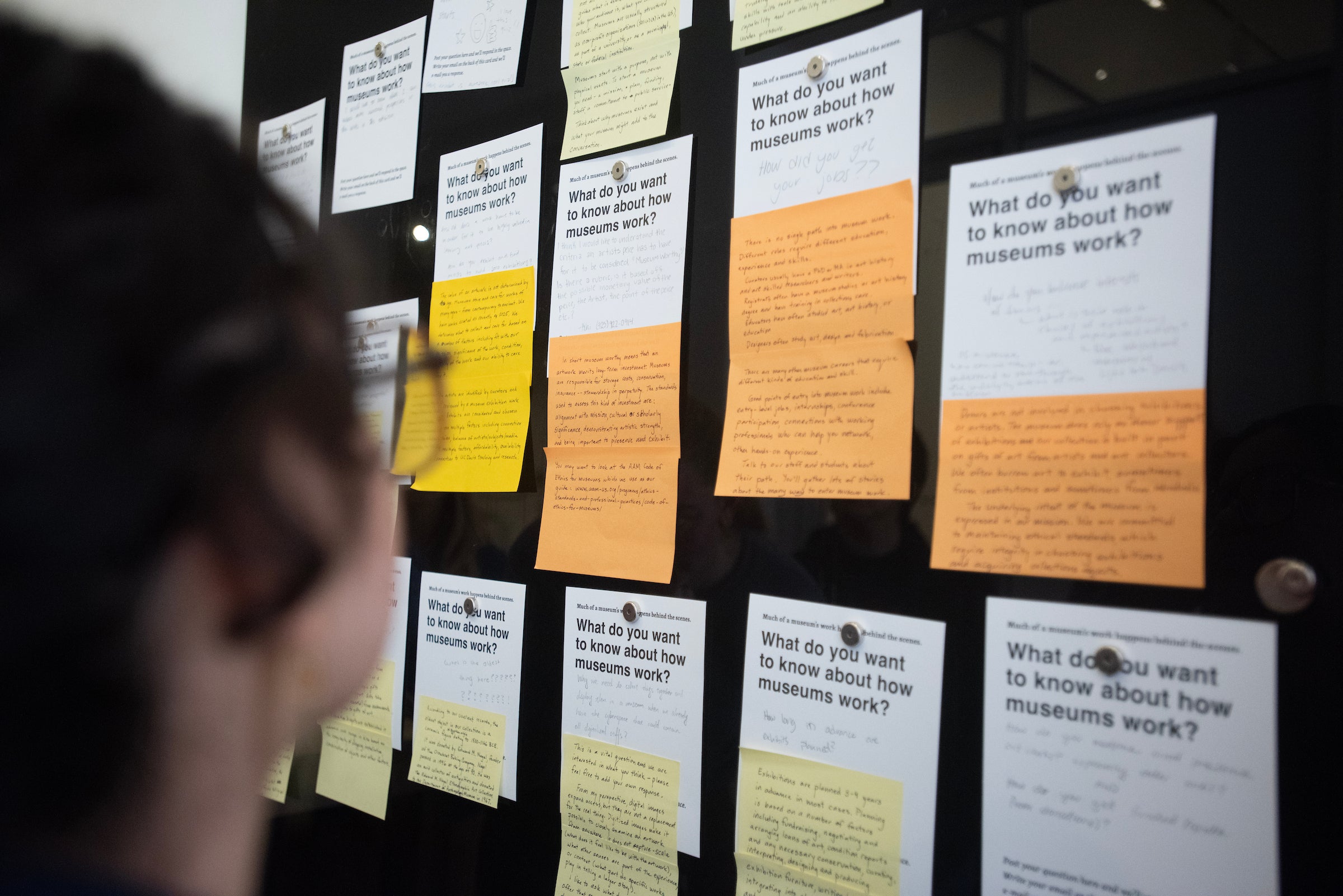 A wall of sticky notes with questions and answers