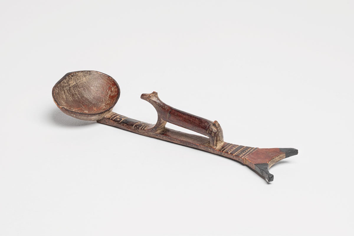 African spoon in brown, woodlike substance, part of Crocker Museum exhibition