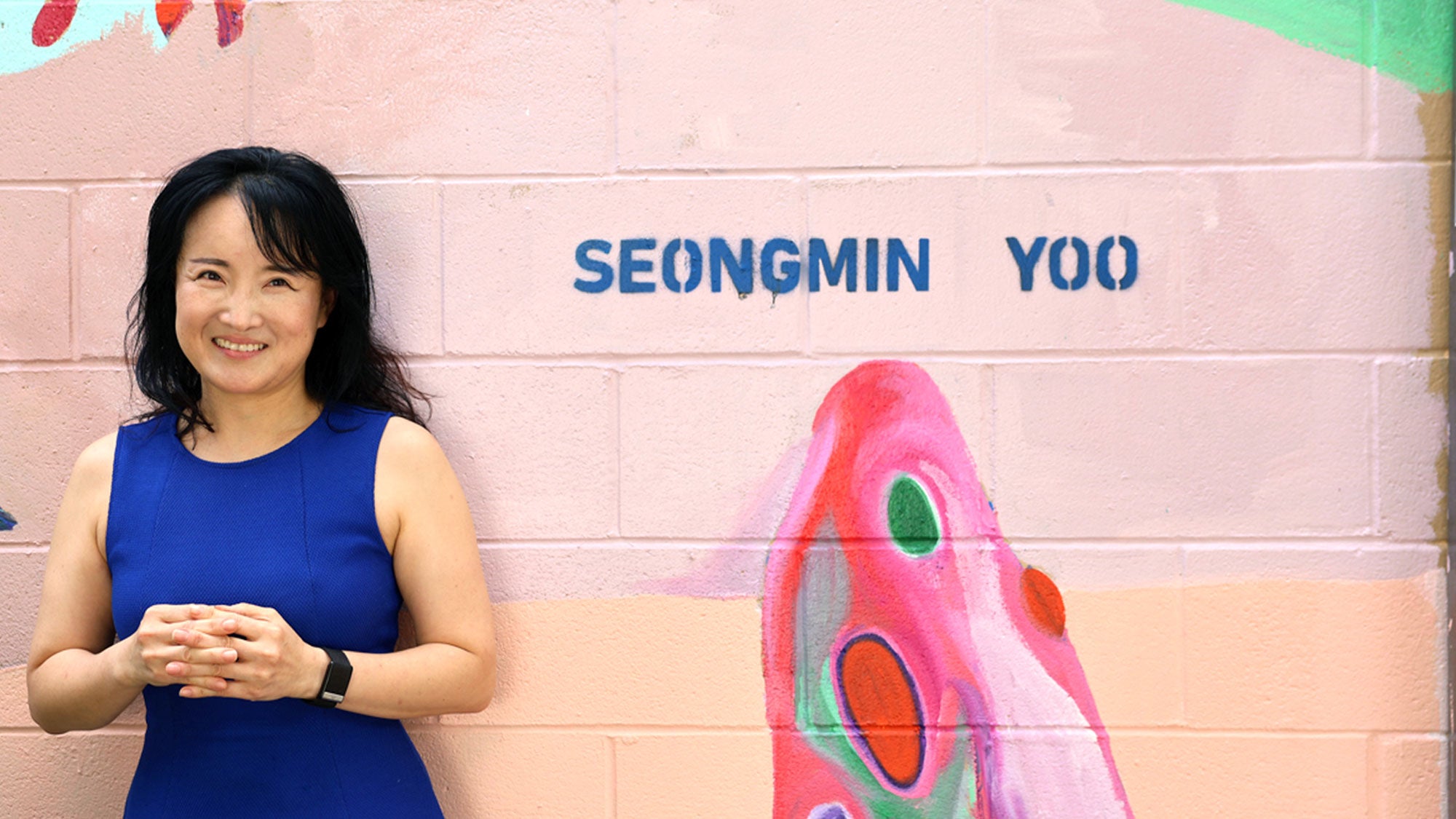 Yoo, creator of mural, stands by her name on the Welcome to Davis mural