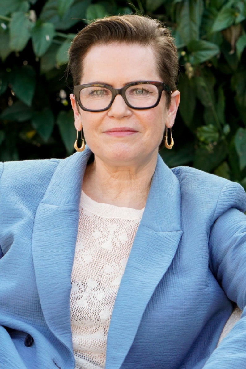 Woman in blue, sitting outside