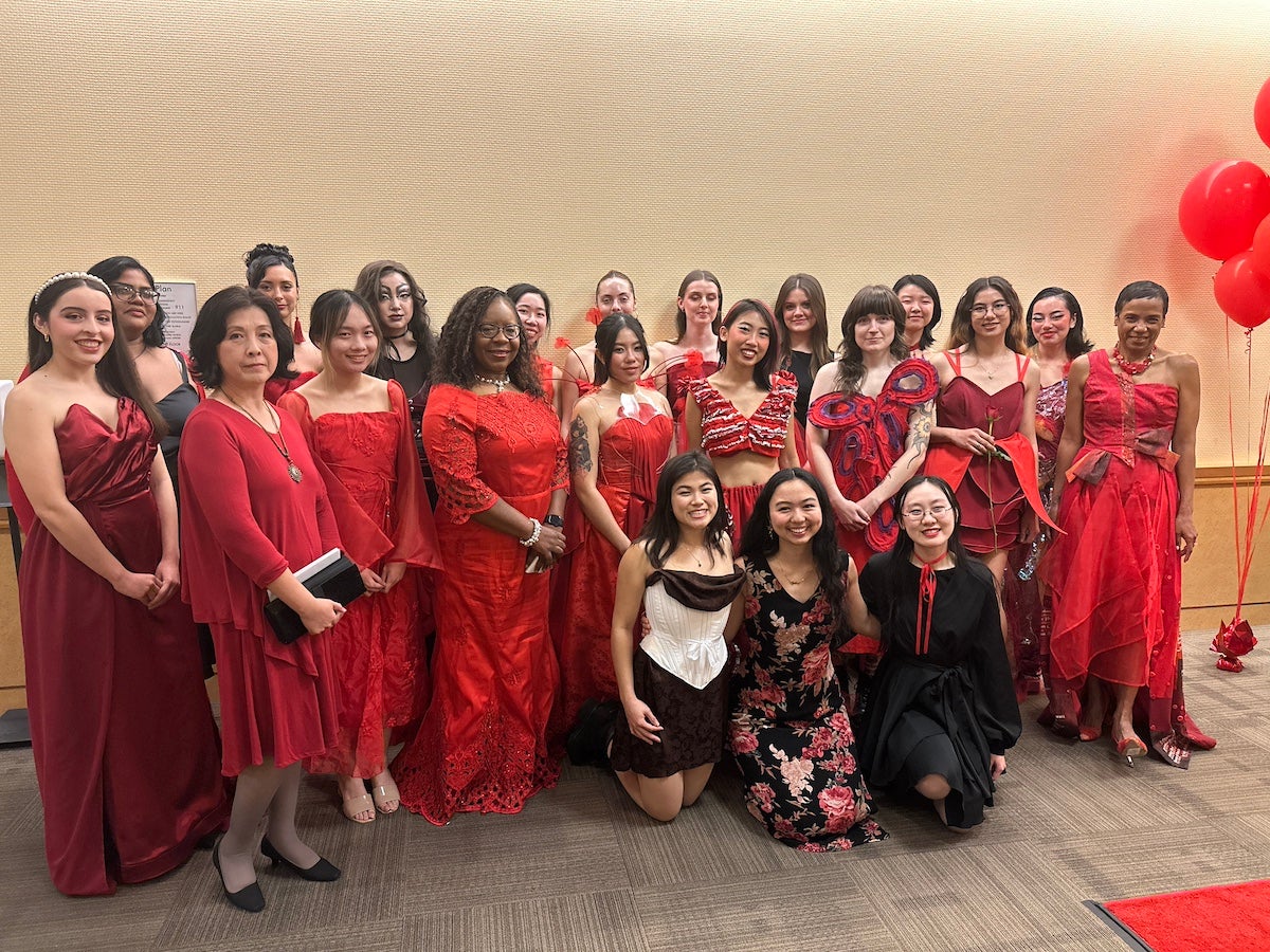 Adele Zhang (second to left), Estella Atekwana (fourth to left) and LeShelle May (far right) posed with student desingers and models who participated in the UC Davis Red Dress Collection fashion show in 2024.(Tracy Sellers/ UC Davis)