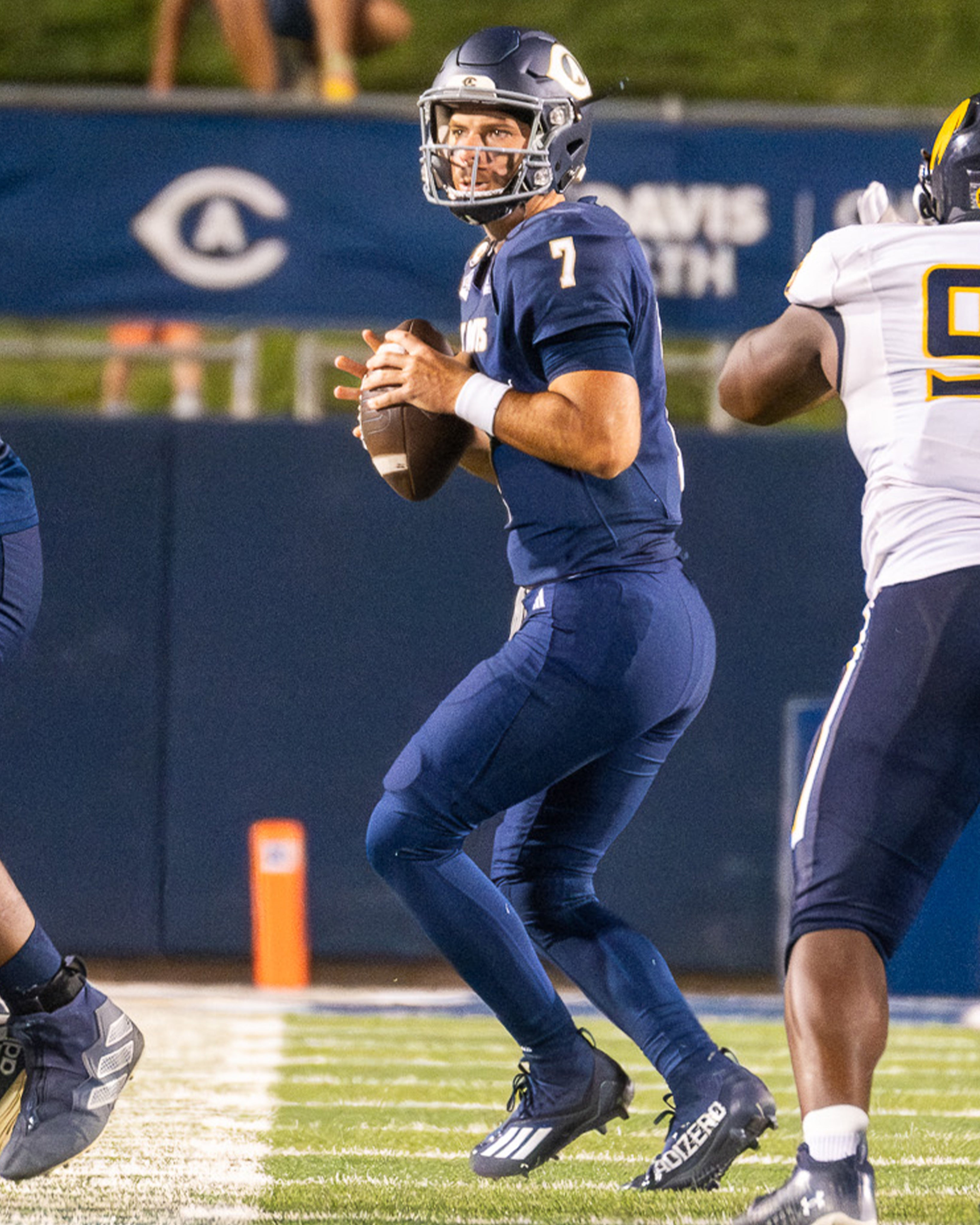 Football player looks for someone to pass the ball to