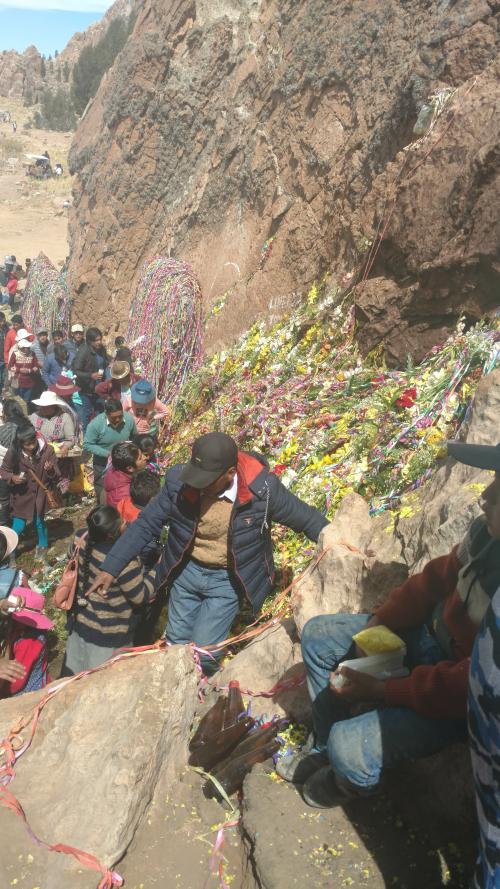 People in Peru journey to a pilgrimage site on rocky hillside 