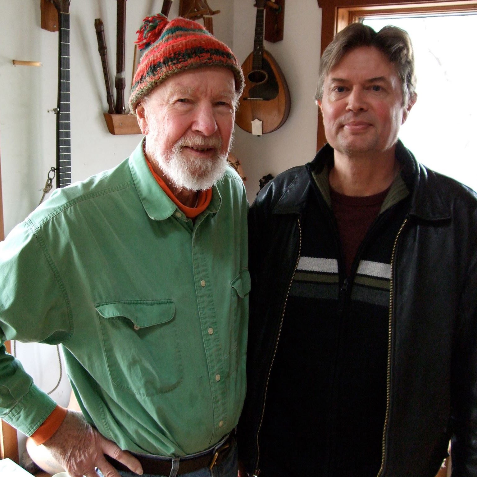 Two men stand next to each other, one is folk legend Pete Seeger