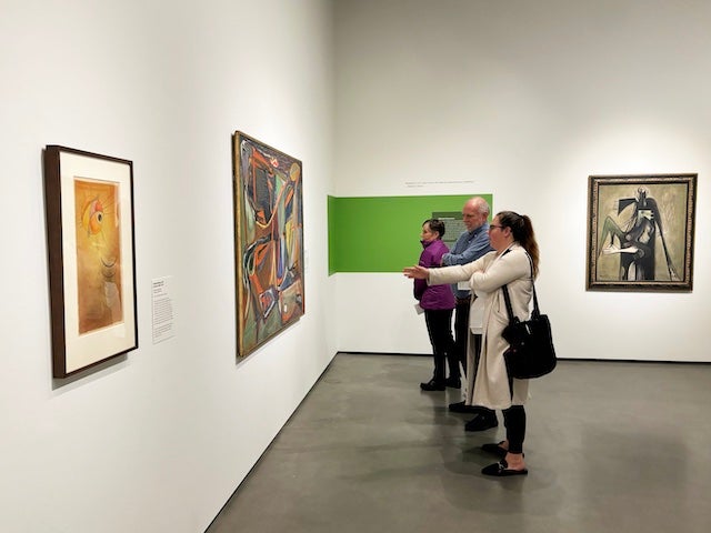 Visitors engage with the paintings during the winter opening of "Light Into Density" at the Jan Shrem and Maria Manetti Shrem Museum of Art. (Courtesy, Manetti Shrem Museum)
