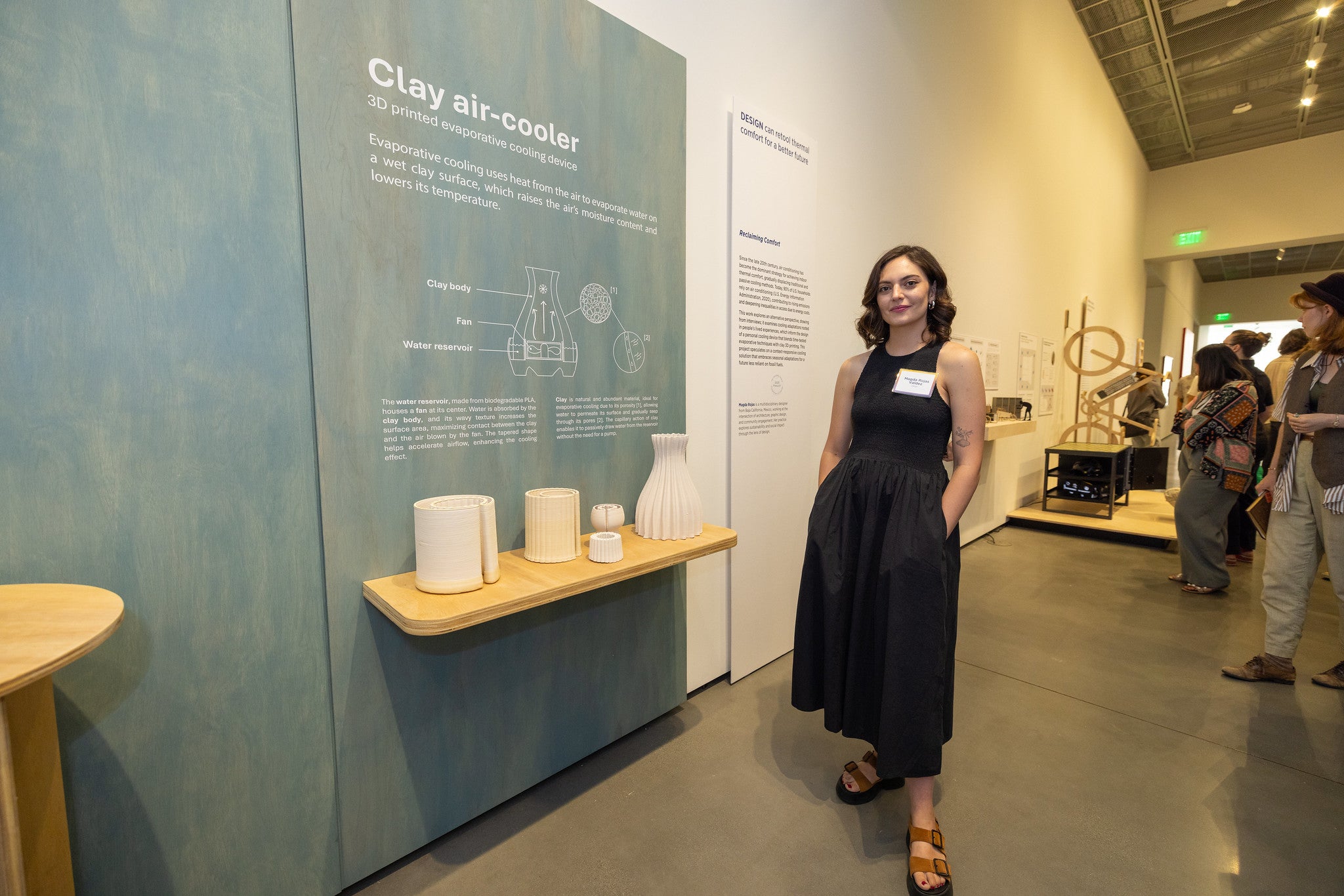 Woman stands by design of cooling system at exhibition