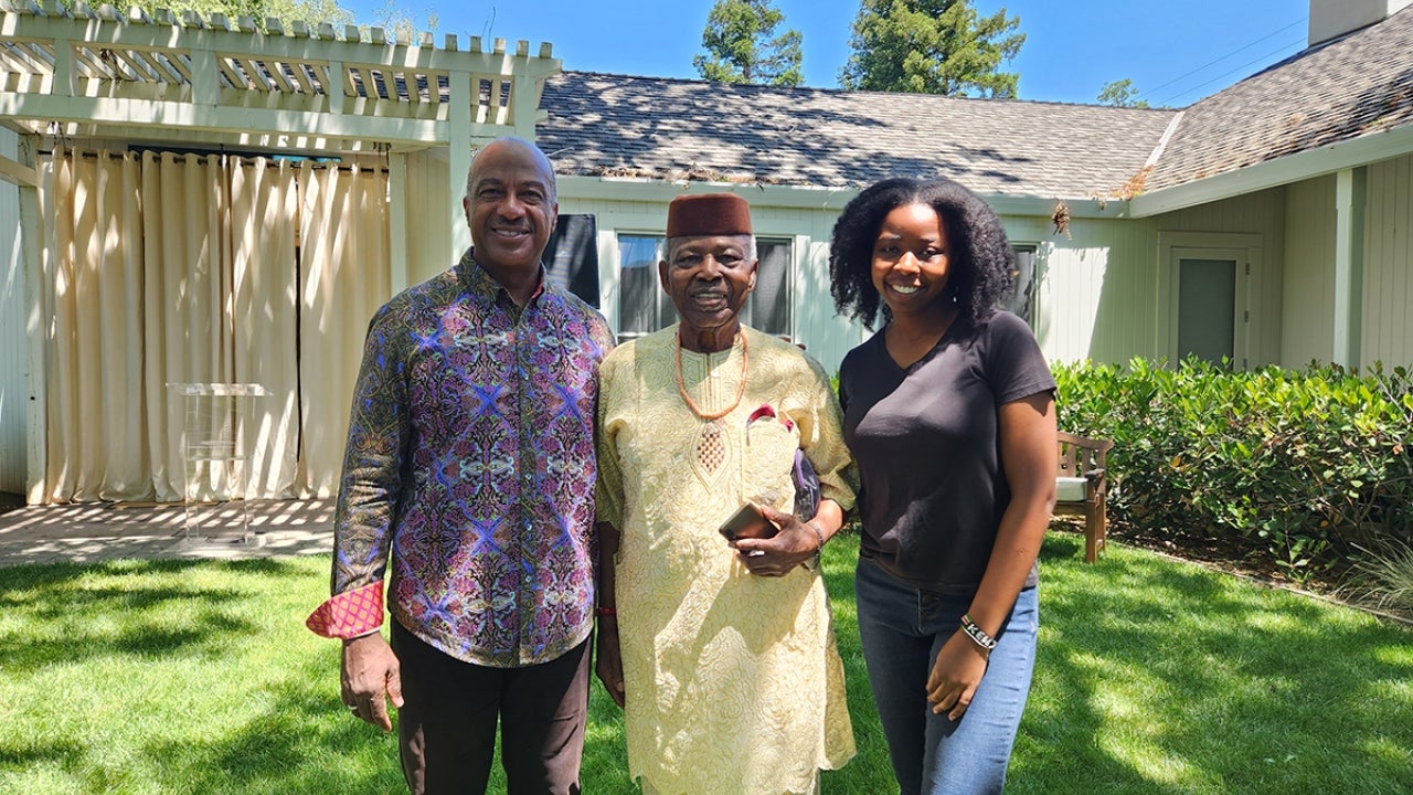 Three people pose for photograph