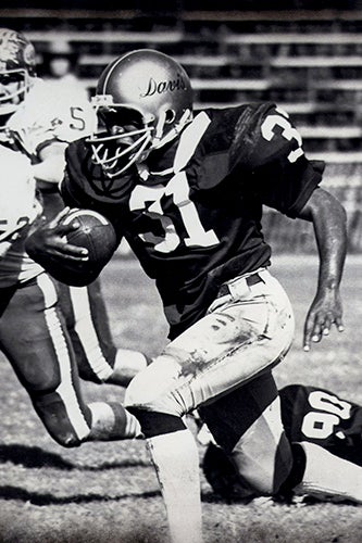 Ron Austin rushes with the football in a game from his time as an Aggie