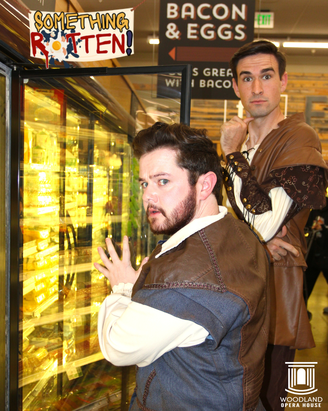 Men pictured near "Something Rotten" sign