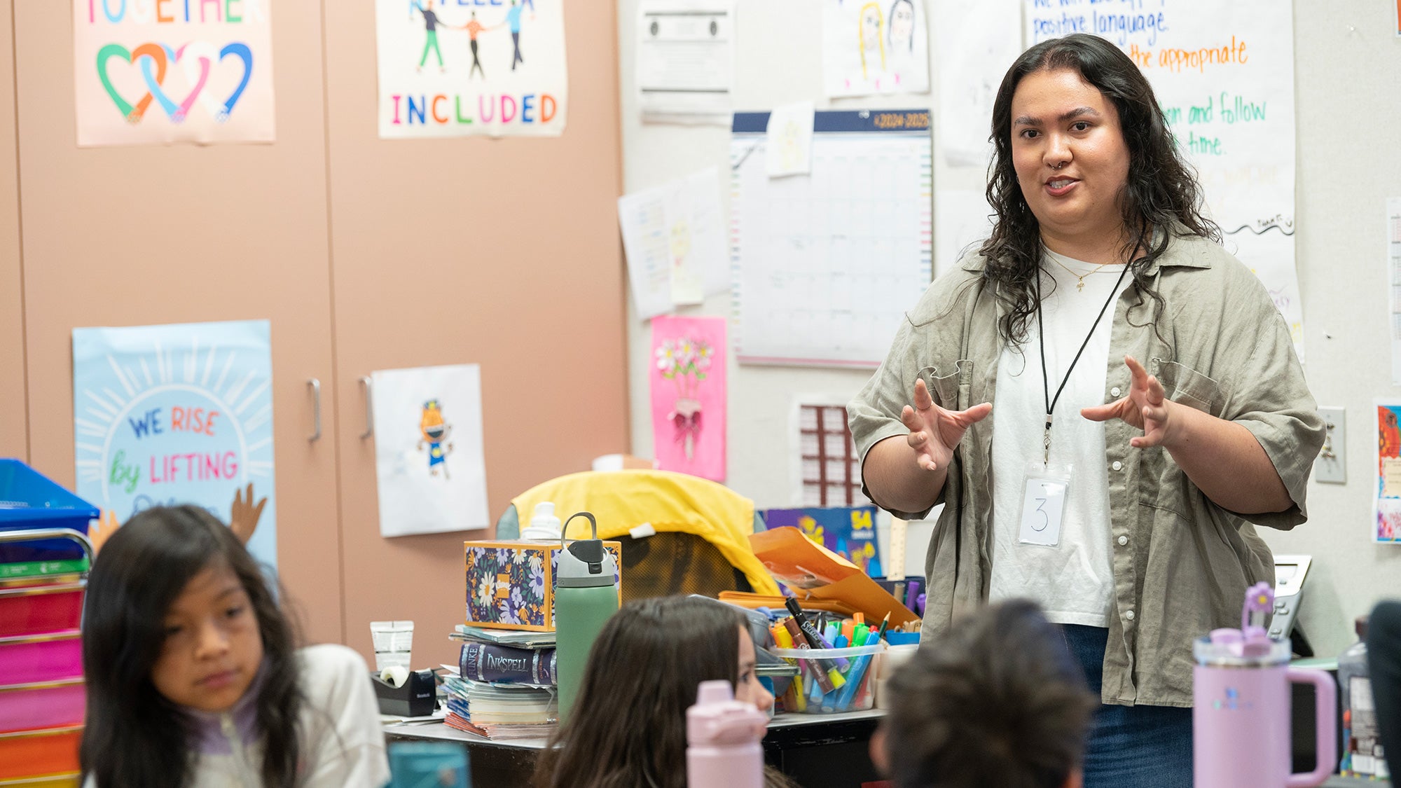 College student stands in front of a class at an elementary school