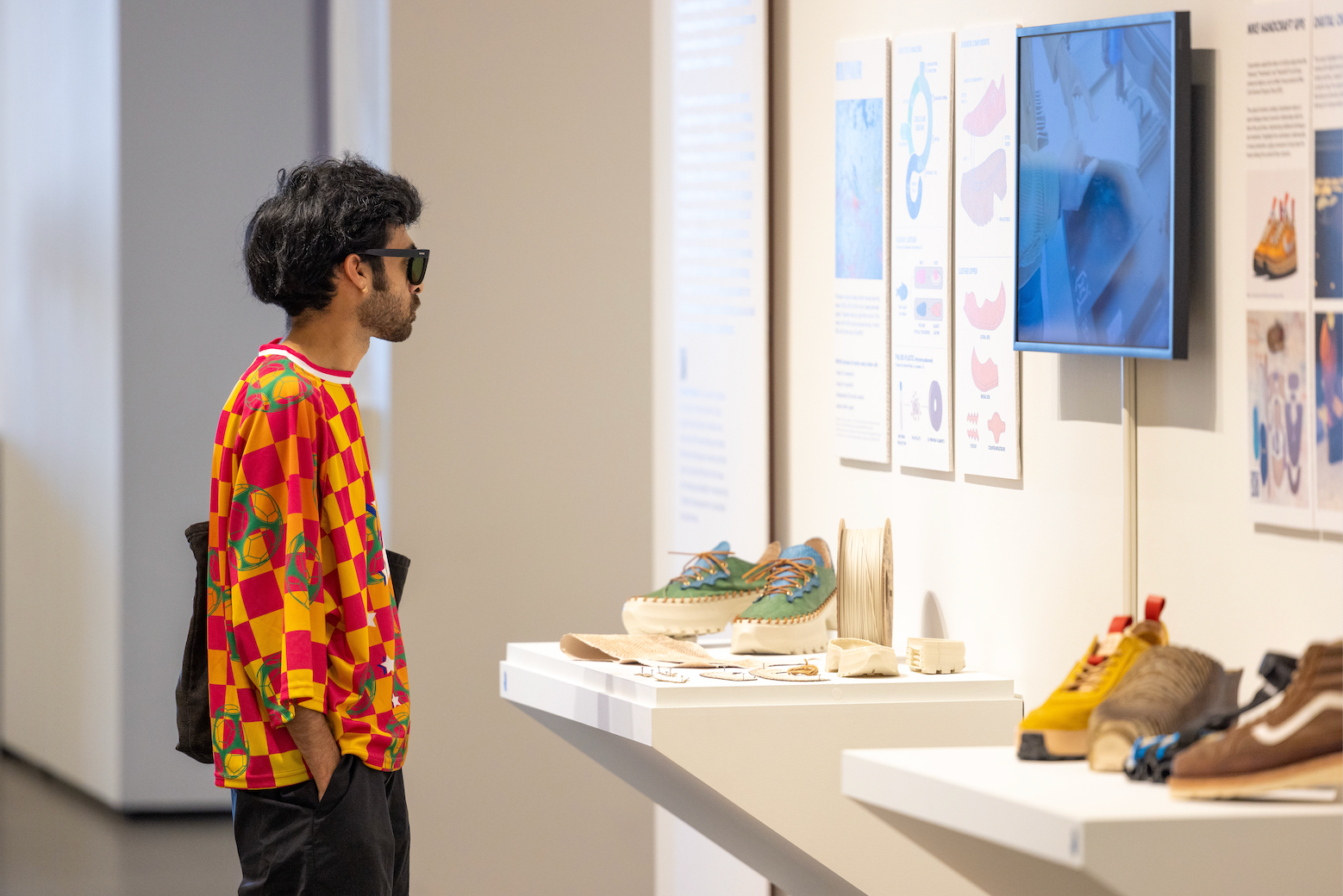 A visitor looks at work by Savageau Award winner and design M.F.A. Damien Mitchell at the Arts & Humanities 2024 Graduate Exhibition. (Hung Q. Pham/ Photography)