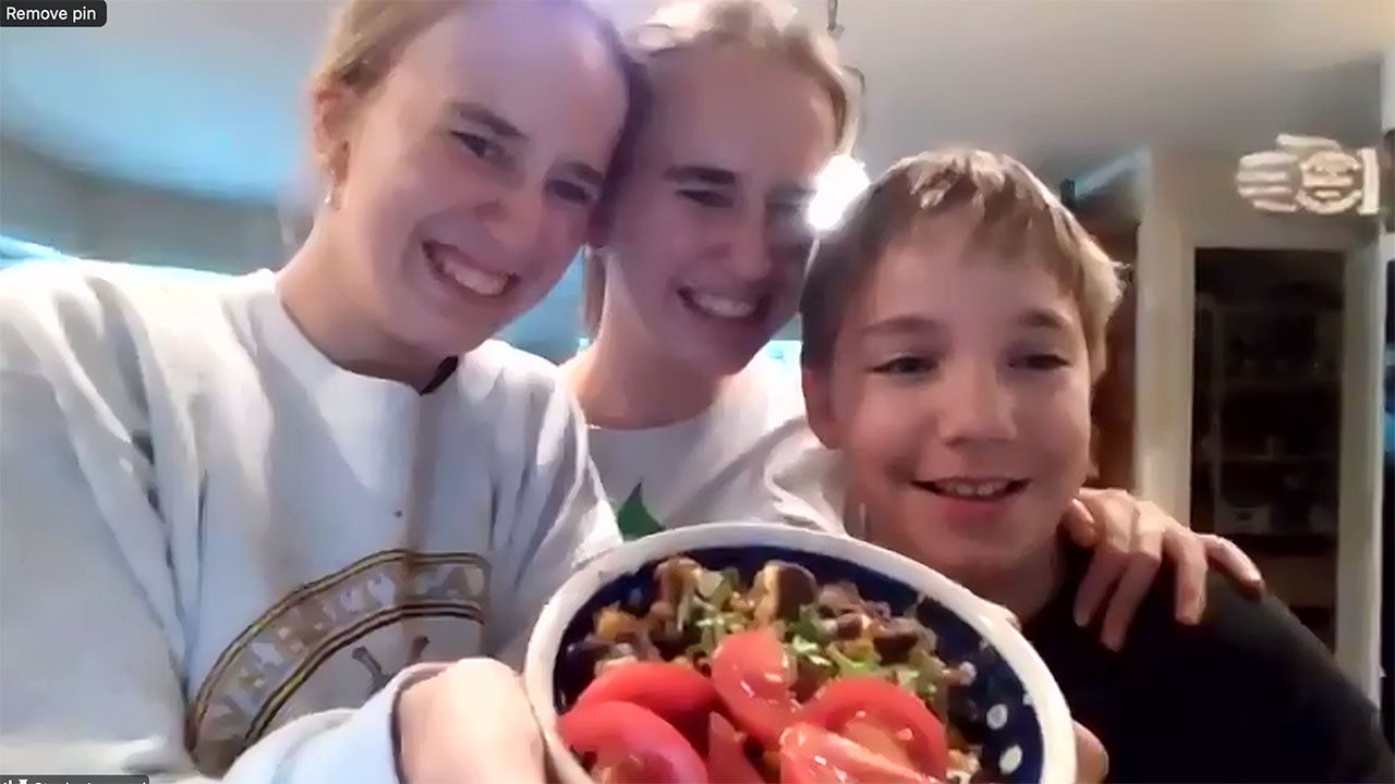 In a screenshot from Zoom, UC Davis student Stasha Leonard, her sister, Charlotte, and their brother Ben pose with a bowl of food with sliced tomatoes.