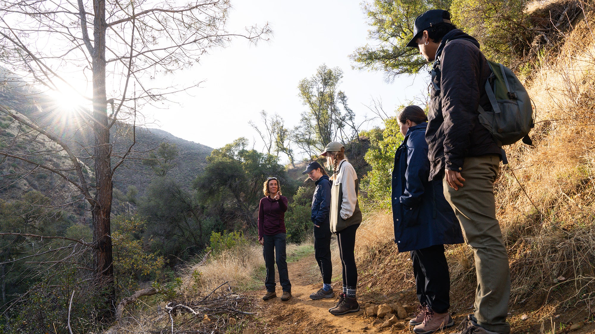A teacher and students on a hiking trail
