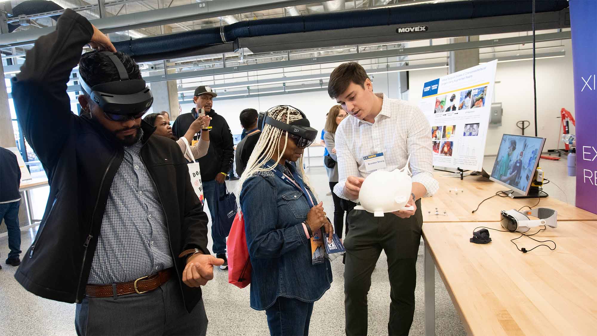 People try on virtual reality headsets