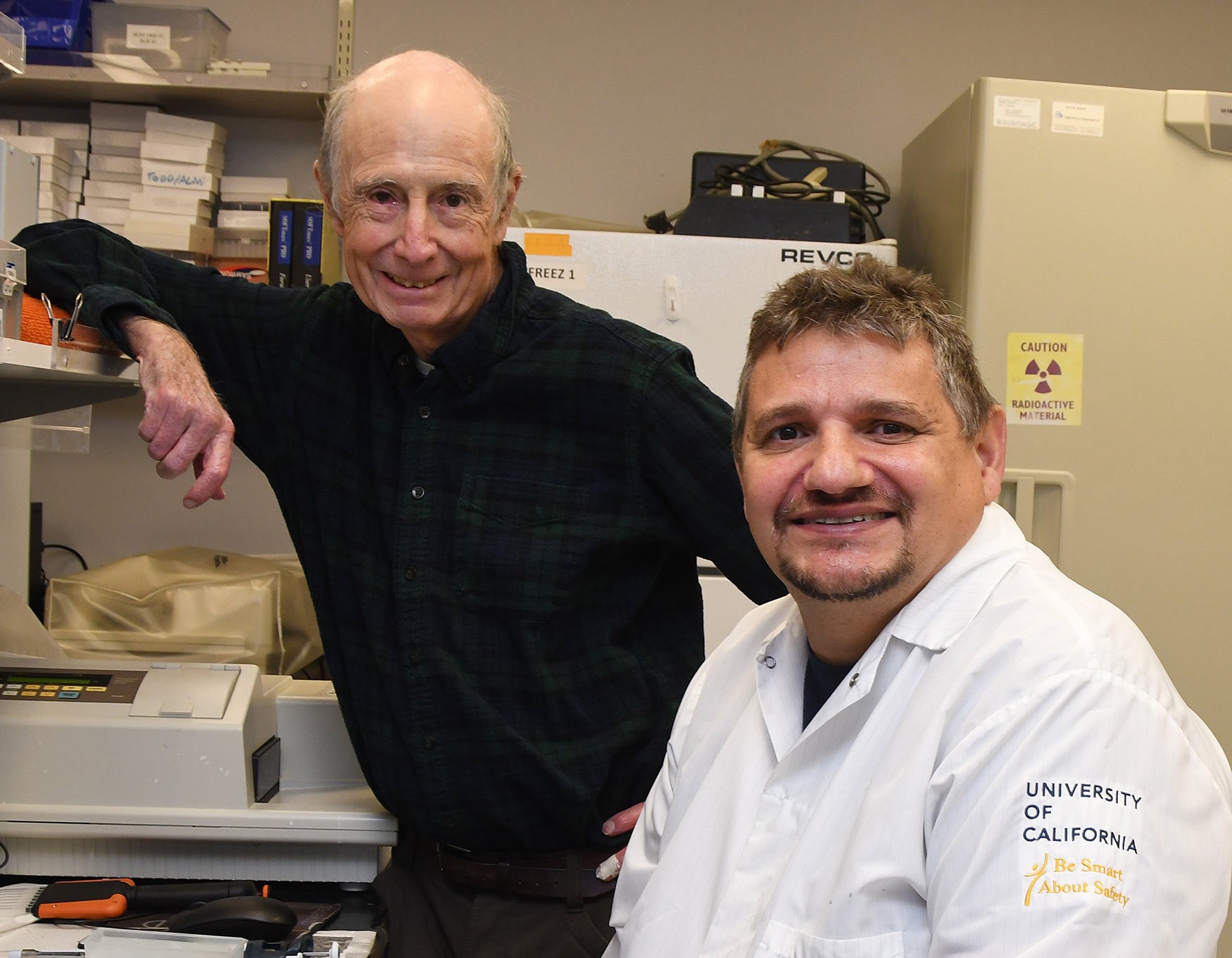 Two men in lab, posing for portrait