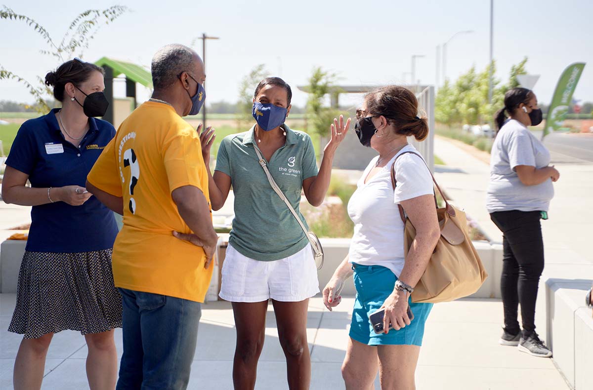 Chancellor Gary S. May and LeShelle May help people move in to The Green at West Village.