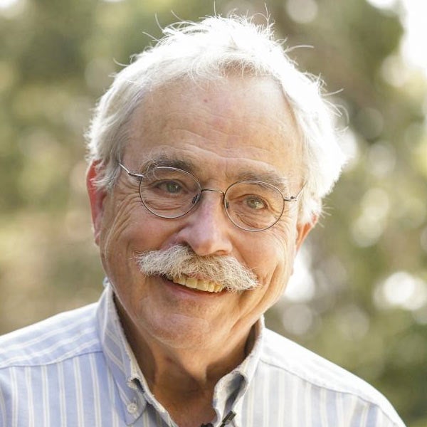 A portrait of a person in front of the UC Davis Arboretum