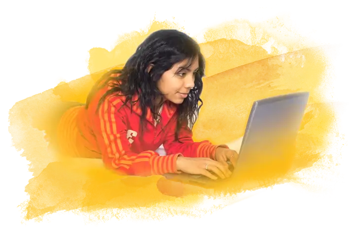A student laying on their stomach looking at their laptop over a yellow watercolor brush background