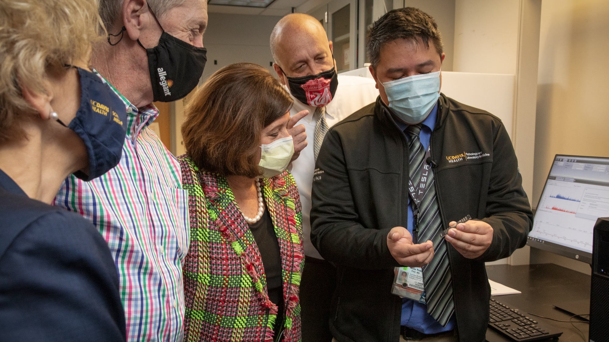 Group looks at data, in lab.