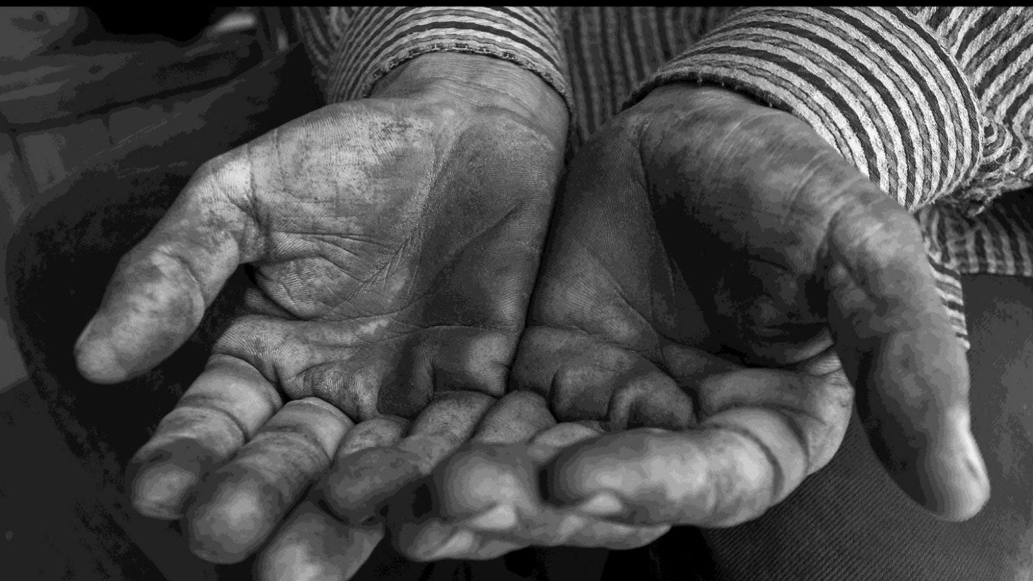 Black and White photo of dirty hands of laborer; part of library photo exhibition