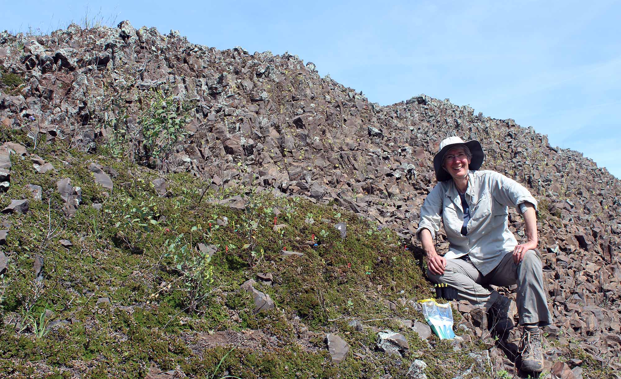 Johanna Schmitt sits on a rocky hillside