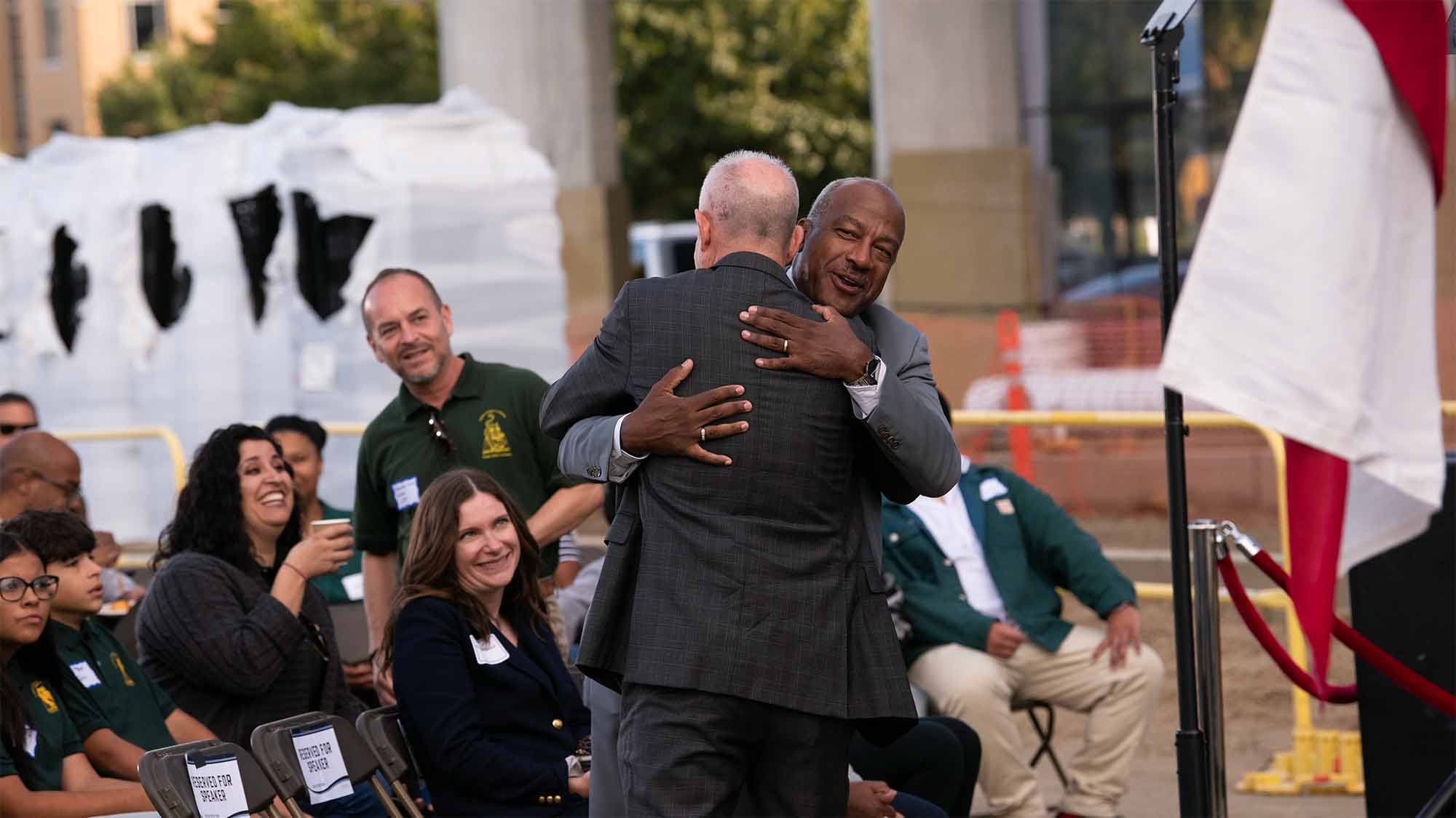 Gary S. May hugs Darrell Steinberg