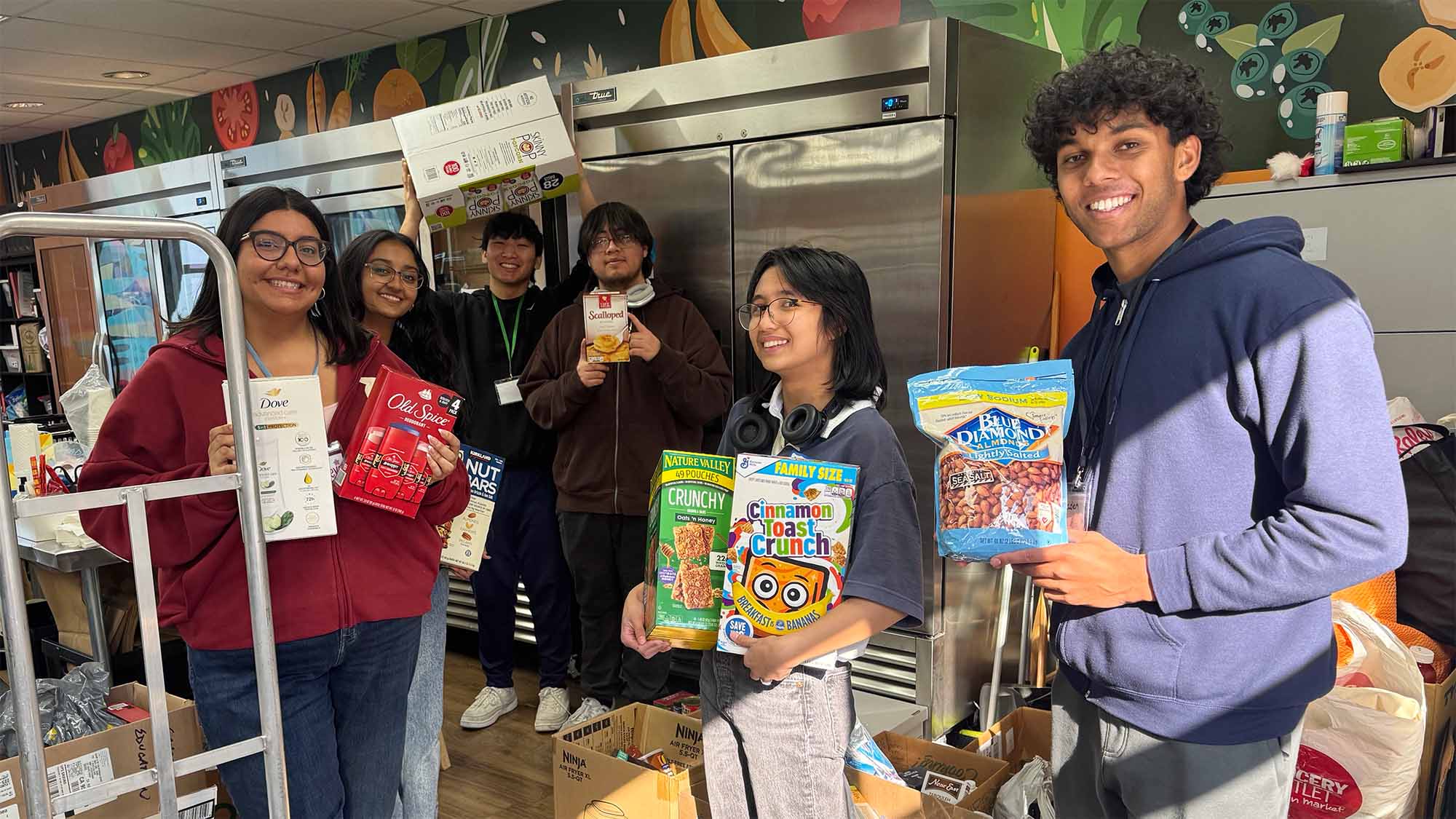 Students hold up food items