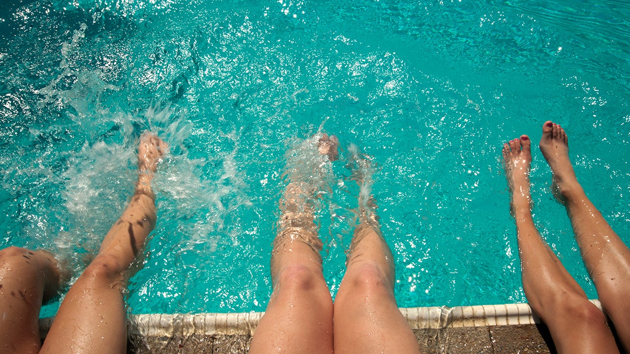 Close up of students dipping their legs in at the Rec Pool.