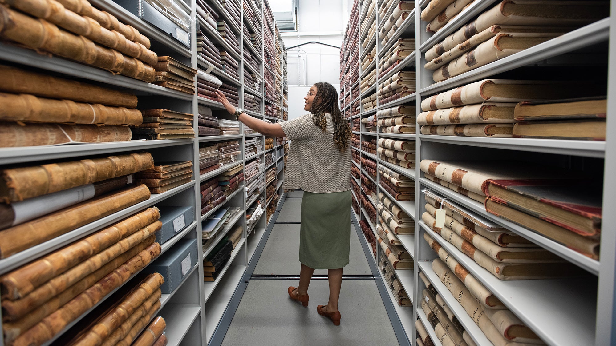 Student walks down the aisles at the Yolo County Archives
