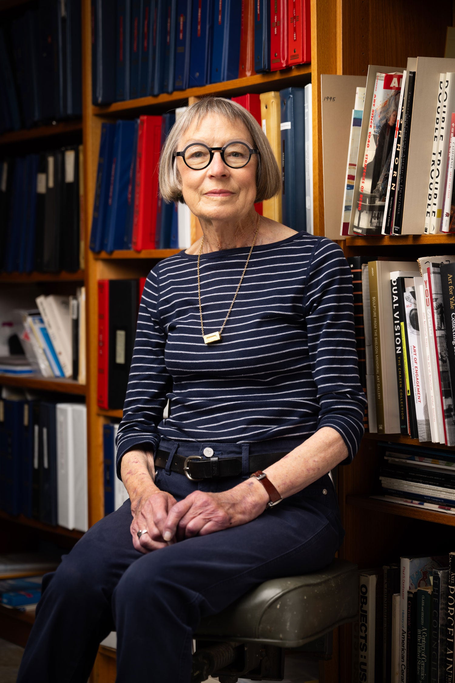 woman in front of bookshelf