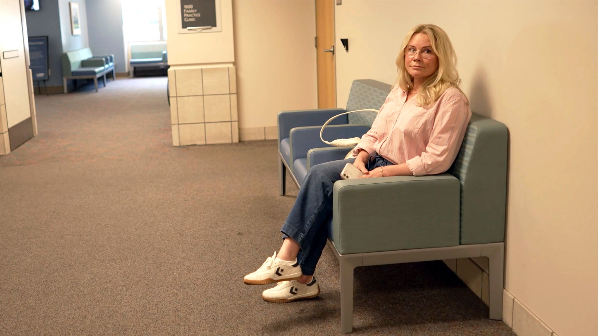 Woman sits in a doctor's waiting area