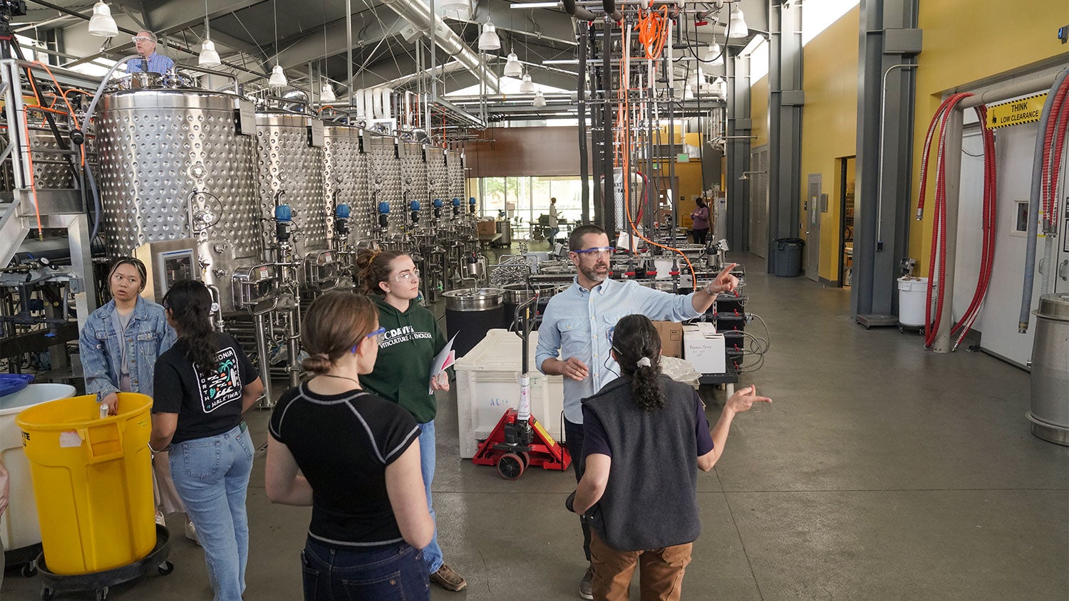 VEN127L instructors David Block (top left), Ben Montpetit (center background) and Leticia Chacon-Rodriguez (center foreground) guide their students through the state-of-the-art Teaching and Research Winery. (Karin Higgins/UC Davis)