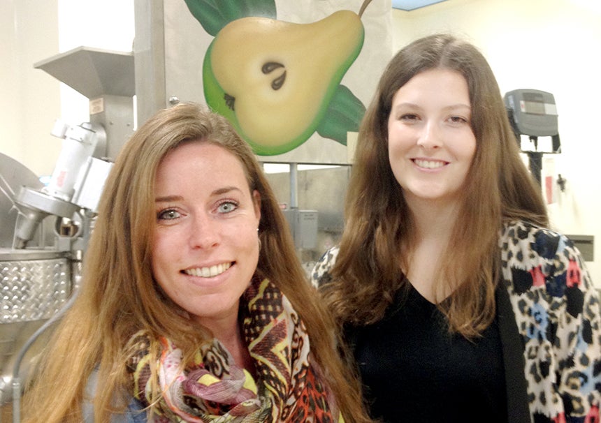 Tw college women stand in UC Davis food-processing pilot plant.