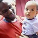  Basketball player holds child