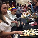 Students cook food for the International Student Fair.