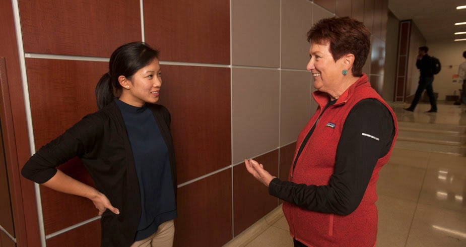 Judith A. Kjelstrom in conversation with a graduate student