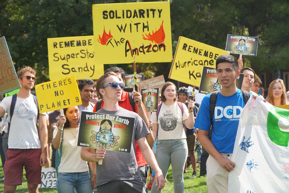 Climate strike participants holding signs.