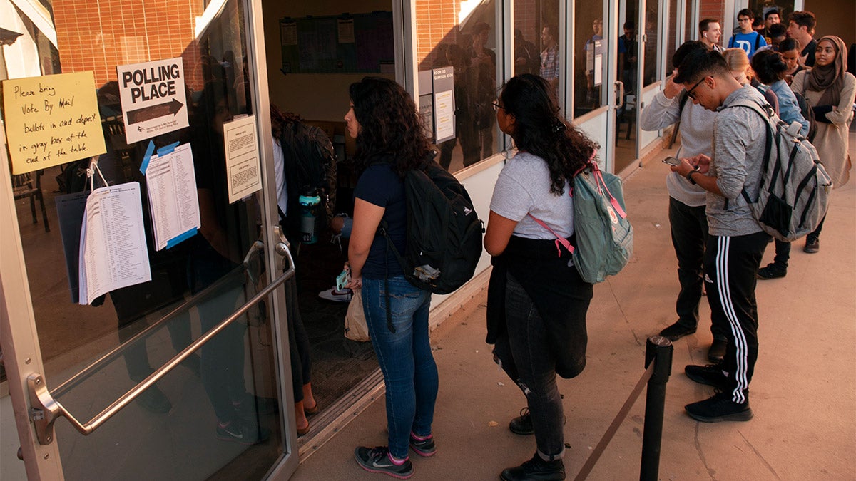 Students wait in line to vote.